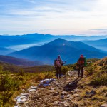 Sportive Couple walking on rural Road foggy Mountains Sunset