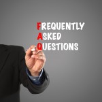 Business man hand writing FAQ acronym